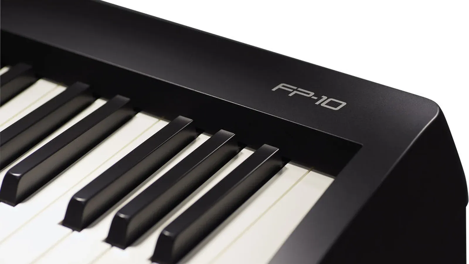 Close-up of the Roland FP-10 keys with the FP-10 logo, showing the matte ivory-feel white keys and black keys