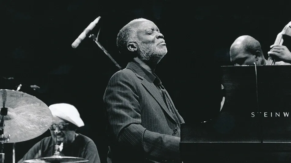Jazz pianist Ahmad Jamal seated at a grand piano