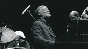 Jazz pianist Ahmad Jamal seated at a grand piano